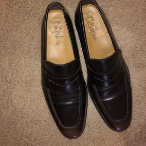 Men’s Cole Haan black slip on dress shoes.